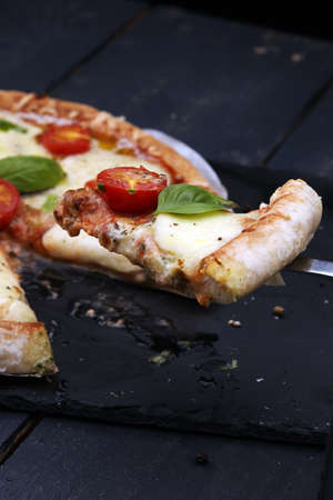 Hot true PEPPERONI ITALIAN PIZZA with salami and cheese. TOP VIEW Tasty traditional pepperoni pizza on board on wooden table with decorationの写真素材
