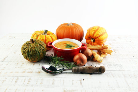 Pumpkin soup on a wooden tableの写真素材
