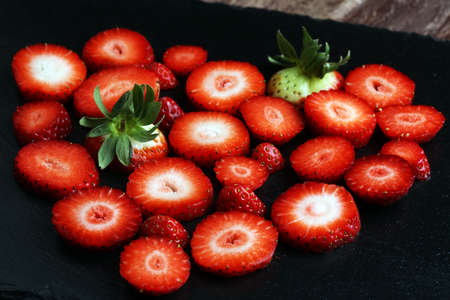 Fresh strawberries array heart shape on old wooden backgroundの写真素材