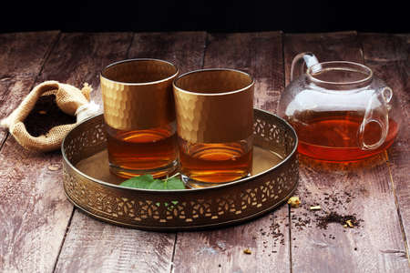 Tea. Herbal tea. Mint leaf. Tea in a glass cup, mint leaves, dried tea, sliced lime. herbs on a slate plate in a restaurant or teahouseの写真素材