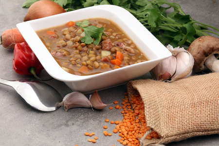 Lentil soup in a bowl on gray backgroundの写真素材