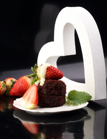 cake for Valentine day with chocolate, white chocolate and strawberriesの写真素材