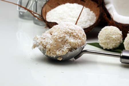 Half of coconut with fresh ice cream on whiteの写真素材