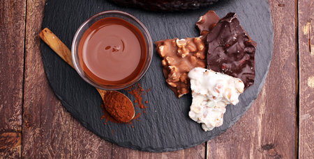 Melting chocolate and diffrent bars - stack and chips with chocolate swirl/ powder and cocoa pod