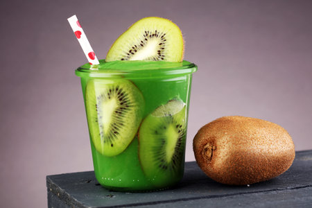 Healthy green smoothie from spinach and kiwi on a wooden tableの写真素材