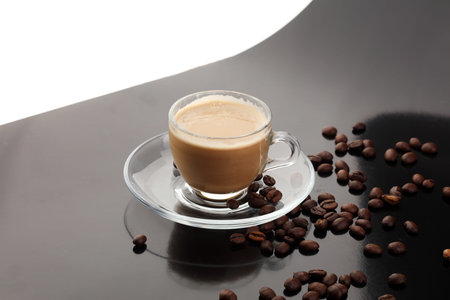 Coffee cup and coffee beans on table