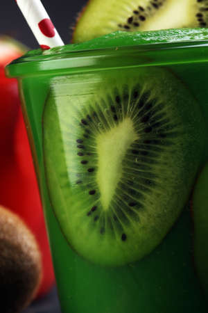 Healthy green smoothie from spinach and kiwi on a wooden tableの写真素材