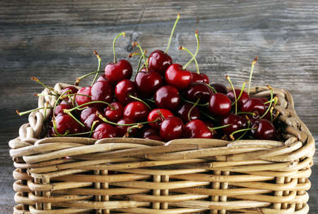 Cherry basket / Sweet cherry background/ cherry with leaf on greyの写真素材