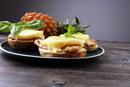 toast hawaii, , cheese and pineapple on wooden background with chicken breastの写真素材