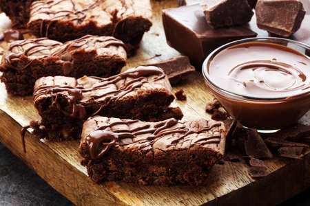 Brownie stack, chocolate cake on rustic wooden board on tableの写真素材