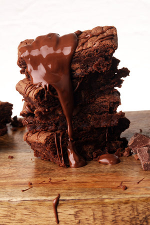 Brownie stack, chocolate cake on rustic wooden board on tableの写真素材