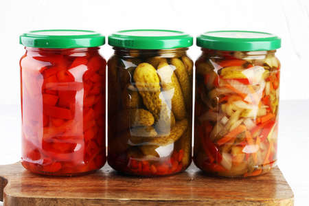 Jar with variety of pickled vegetables. Carrots, field garlic, parsley in glas. Preserved foodの写真素材