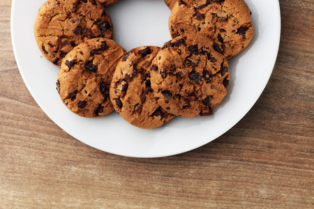 Chocolate cookies on wooden table. Chocolate chip cookies shot