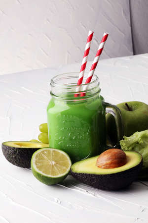 Healthy green smoothie and ingredients - detox, diet, health, vegetarian food conceptの写真素材