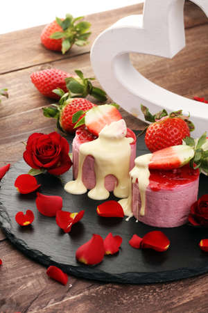 Delicious cupcake for Valentine Day. cake for Valentines day with chocolate and strawberries. Traditional homemade with red rosesの写真素材