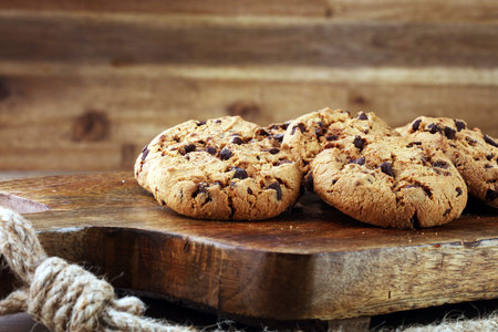 Chocolate cookies on wooden table. Chocolate chip cookies shot