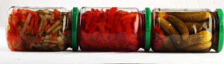Jar with variety of pickled vegetables. Carrots, field garlic, parsley in glas. Preserved foodの写真素材