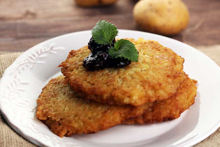 Potato pancake with cow berry sauce, selective focusの写真素材