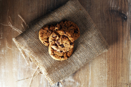 Chocolate cookies on wooden table. Chocolate chip cookies shot