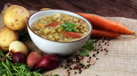 Light summer green pea cream soup in bowlの写真素材