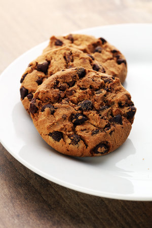 Chocolate cookies on wooden table. Chocolate chip cookies shot