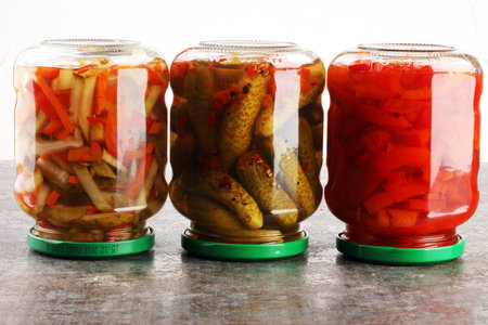 Jar with variety of pickled vegetables. Carrots, field garlic, parsley in glas. Preserved foodの写真素材