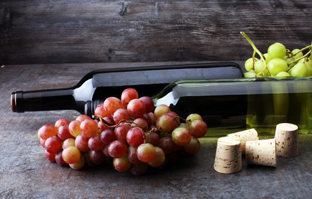 Bottle of white and red wine, grape and corksの写真素材