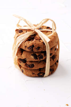 Chocolate cookies on white background with chocolate morselsの写真素材