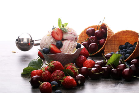 Strawberry ice cream in white bowl with fresh strawberries and mint
