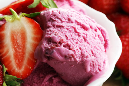 Strawberry ice cream on brown wood background