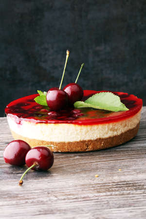 Home made cherry cake with vanilla and black cherries on wooden tableの写真素材