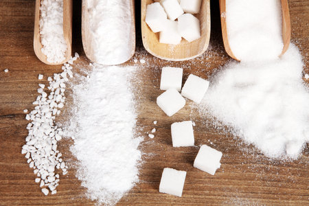 scoop with white sand and lump sugar on wooden backgroundの写真素材