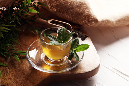 Cup with green tea on brown wooden backgroundの写真素材