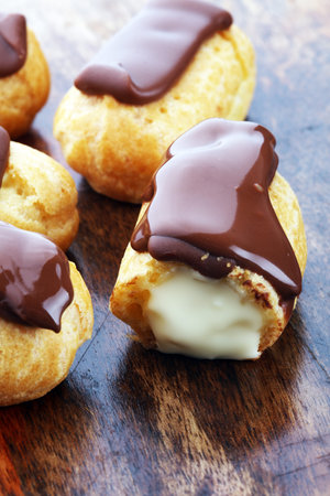 Traditional French dessert. Eclair with chocolate icing. Pastery concept