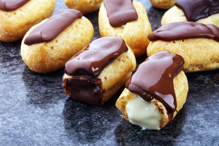Traditional French dessert. Eclair with chocolate icing. Pastery concept