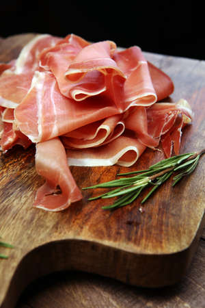 Italian prosciutto crudo or jamon with rosemary. Raw ham.の写真素材