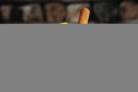 christmas hot mulled wine with cinnamon cardamom and anise on wooden backgroundの写真素材