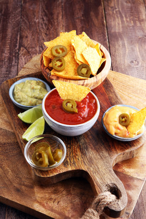 Nachos Tortilla Chips and jalapeños Chili Peppers or Mexican chili peppers with Tomato, Cheese and...