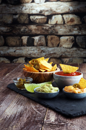 Nachos Tortilla Chips and jalapeños Chili Peppers or Mexican chili peppers with Tomato, Cheese and...