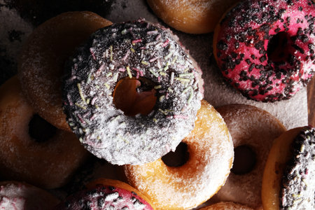 assorted donuts with chocolate frosted, pink glazed and sprinkles donuts.の写真素材