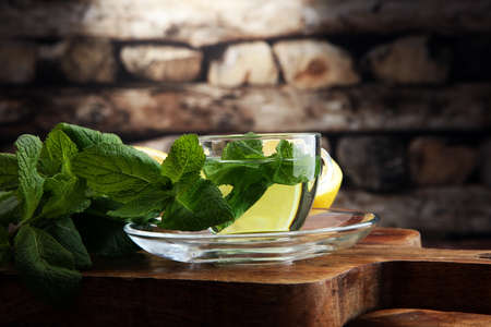 Cup of mint tea and leaves of mint on the table.の写真素材