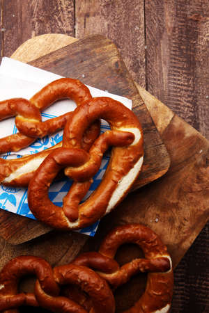 Pretzels on wooden board on rustic background. german food.の写真素材
