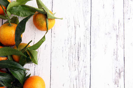 Tangerines with leaves on wooden background. Mandarins Rustic style.の写真素材