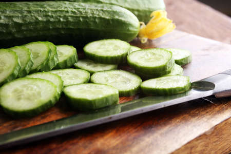 Fresh and sliced cucumbers. Sliced cucumbers on a cutting board. cucumbers for diet and healthy eating.の写真素材