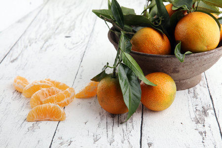 Tangerines with leaves on wooden background. Mandarins Rustic style.の写真素材