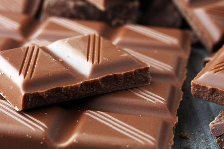 Dark Chocolate chunks and stacked broken chocolate bar.の写真素材