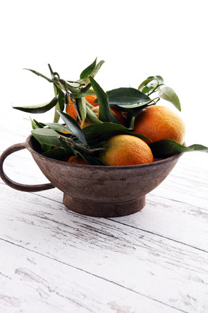 Tangerines with leaves on wooden background. Mandarins Rustic style.の写真素材