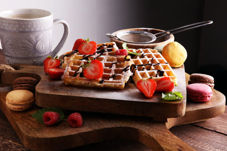 Belgian waffles with strawberries and raspberries, homemade healthy breakfast with coffeeの写真素材