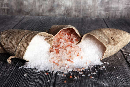 sea salt and himalayan in burlap. Crystals of salt on tableの写真素材