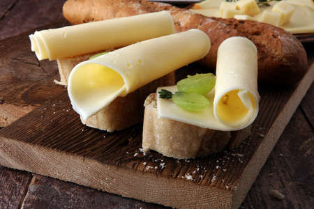 Cheese slices on bread or baghuette and grapesの写真素材